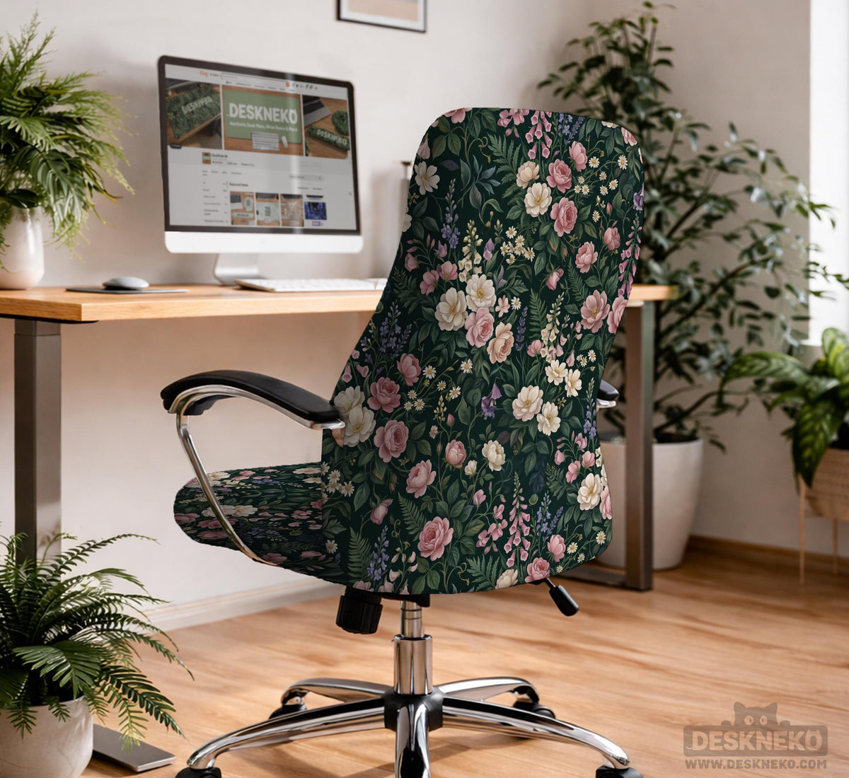 Green chair cover with a dark floral pattern, pink roses, cream flowers, and leafy botanical details on an office chair.