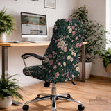 Green chair cover with a dark floral pattern, pink roses, cream flowers, and leafy botanical details on an office chair.