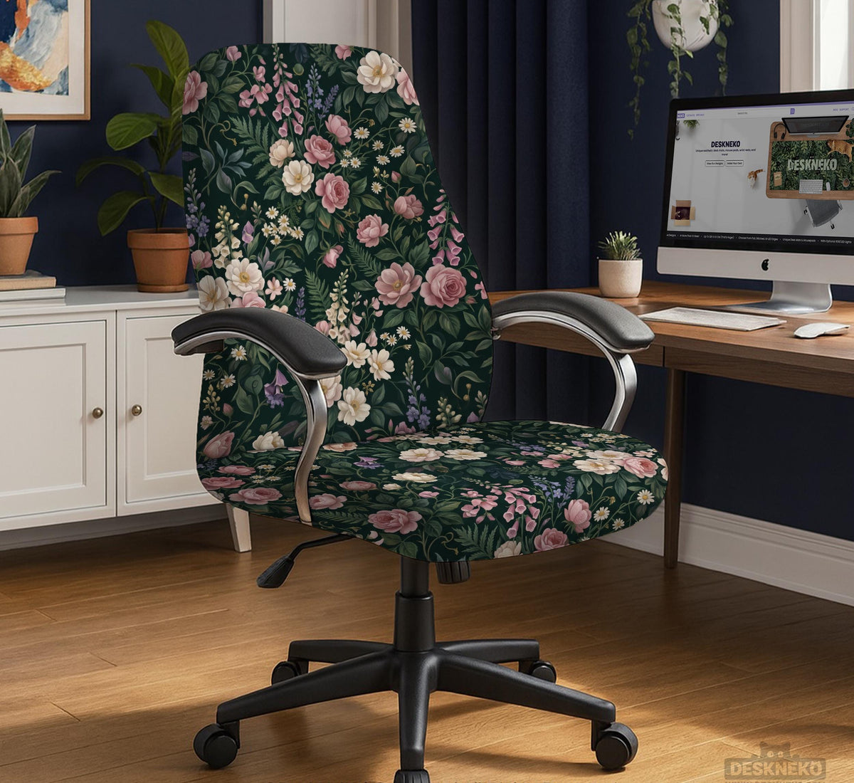 Green chair cover with a dark floral pattern, pink roses, cream flowers, and leafy botanical details on an office chair.