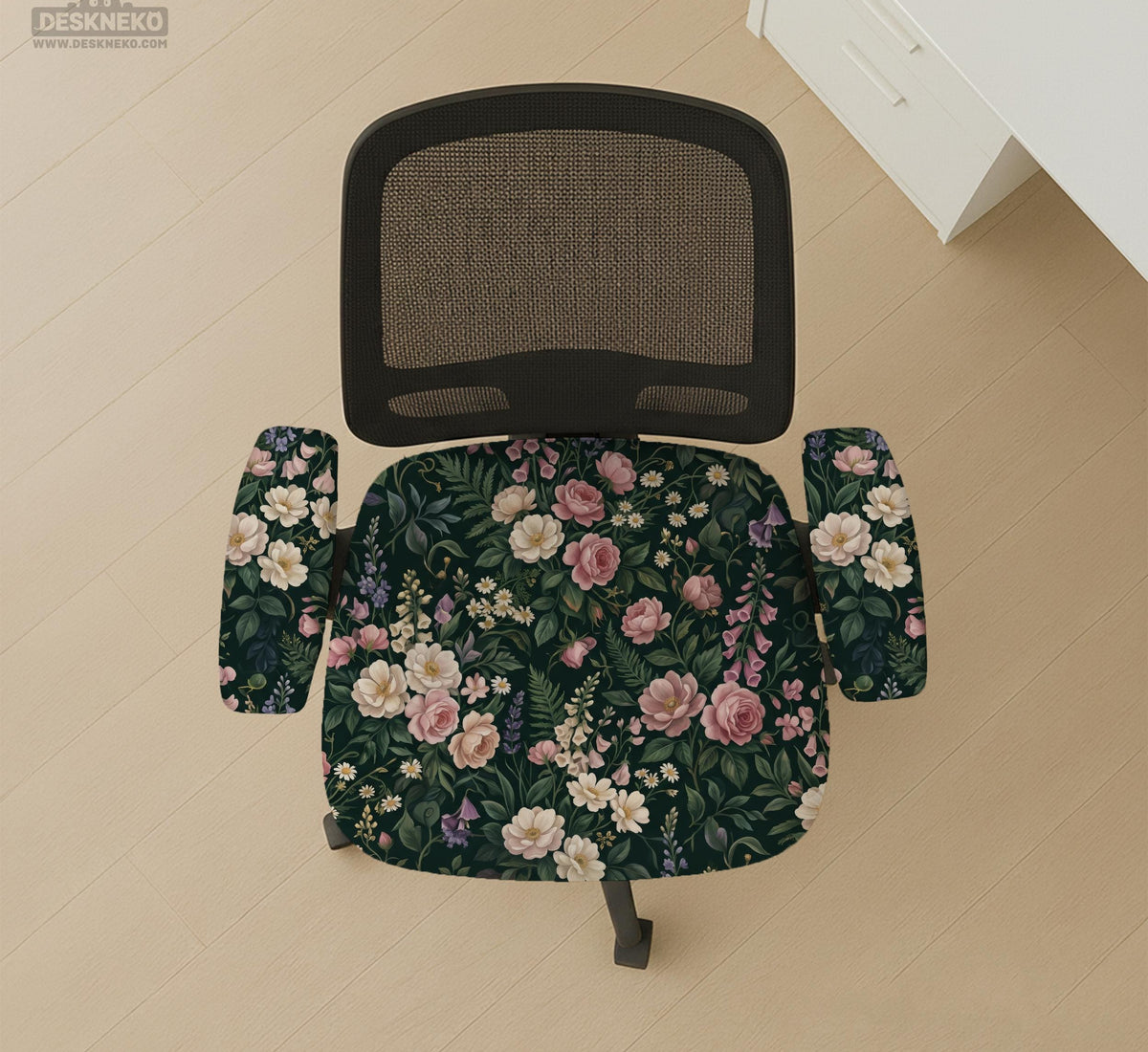 Green chair cover with a dark floral pattern, pink roses, cream flowers, and leafy botanical details on an office chair.