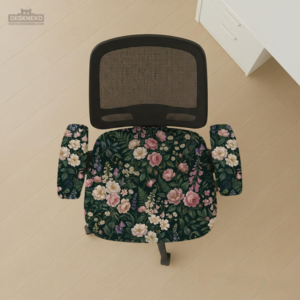 Green chair cover with a dark floral pattern, pink roses, cream flowers, and leafy botanical details on an office chair.