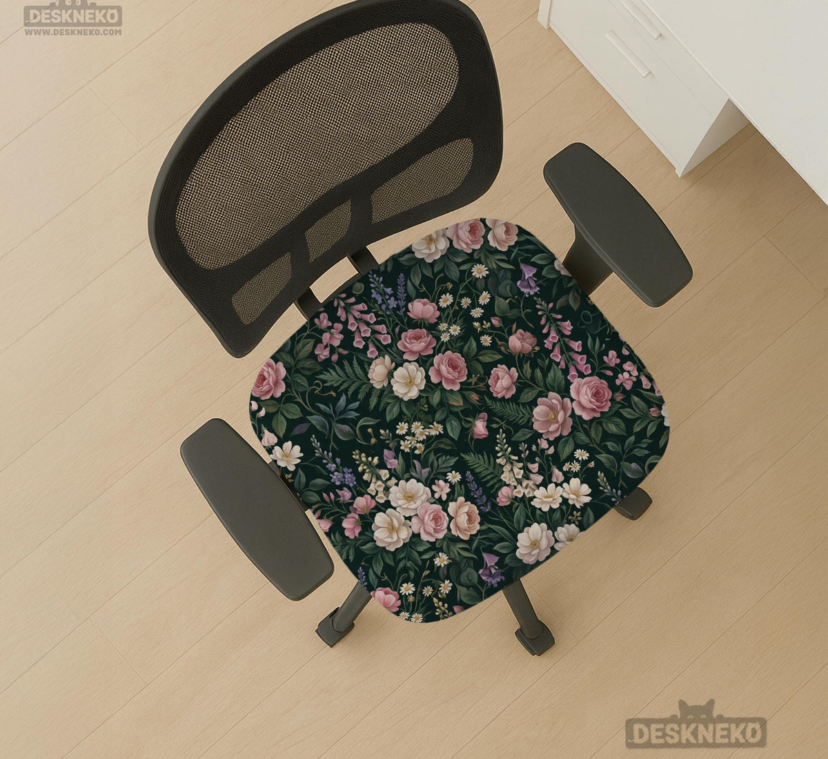 Green chair cover with a dark floral pattern, pink roses, cream flowers, and leafy botanical details on an office chair.