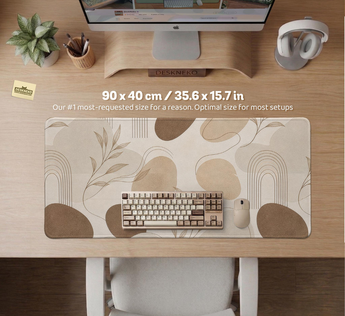 Beige desk mat with fine botanical line drawings and soft abstract shapes on a light neutral background.