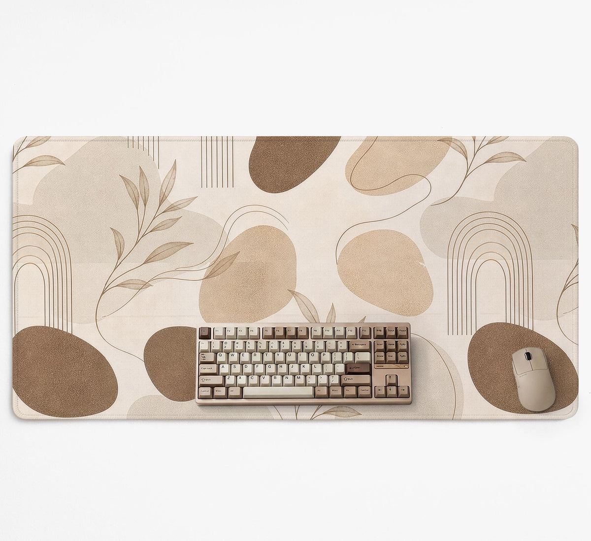 Beige desk mat with fine botanical line drawings and soft abstract shapes on a light neutral background.