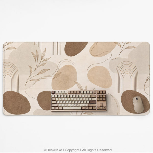 Beige desk mat with fine botanical line drawings and soft abstract shapes on a light neutral background.