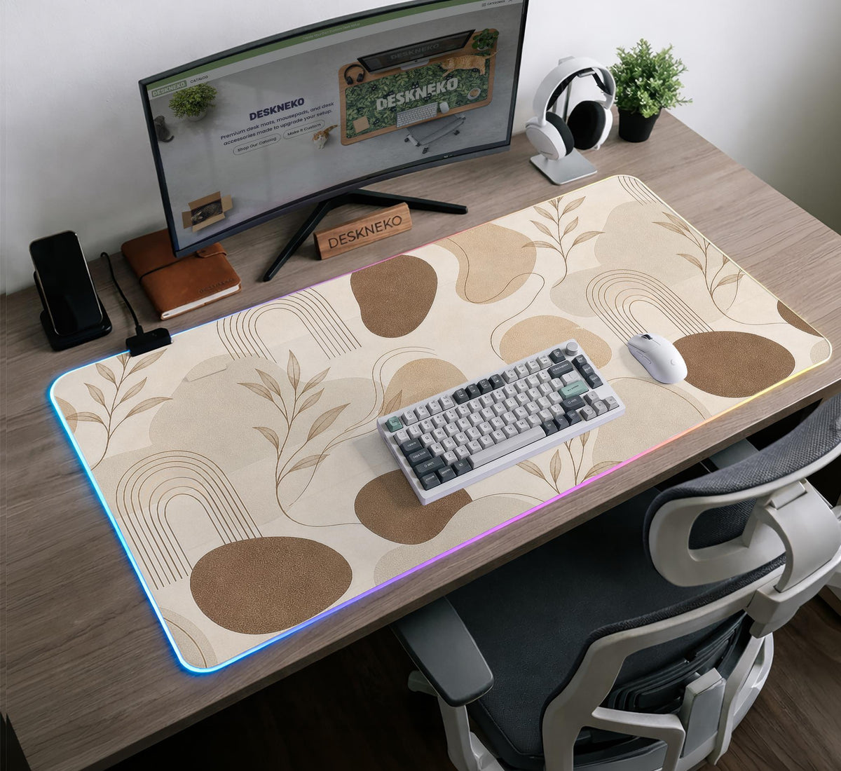 Beige desk mat with fine botanical line drawings and soft abstract shapes on a light neutral background.