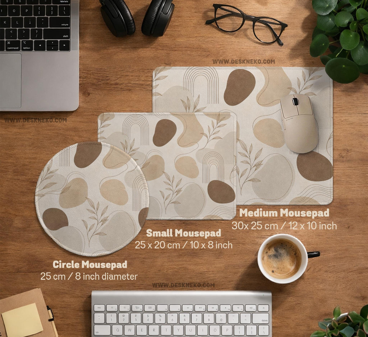 Beige desk mat with fine botanical line drawings and soft abstract shapes on a light neutral background.