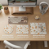 Cream desk mat with a woodland animal pattern featuring foxes, bunnies, mushrooms, berries, acorns, and sage leaves in soft green tones.