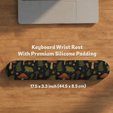 Dark botanical desk mat options with frogs, mushrooms, ferns, and acorns in brown and green tones, plus a matching keyboard wrist rest.
