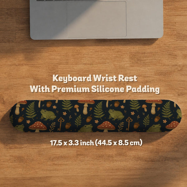 Dark botanical desk mat options with frogs, mushrooms, ferns, and acorns in brown and green tones, plus a matching keyboard wrist rest.