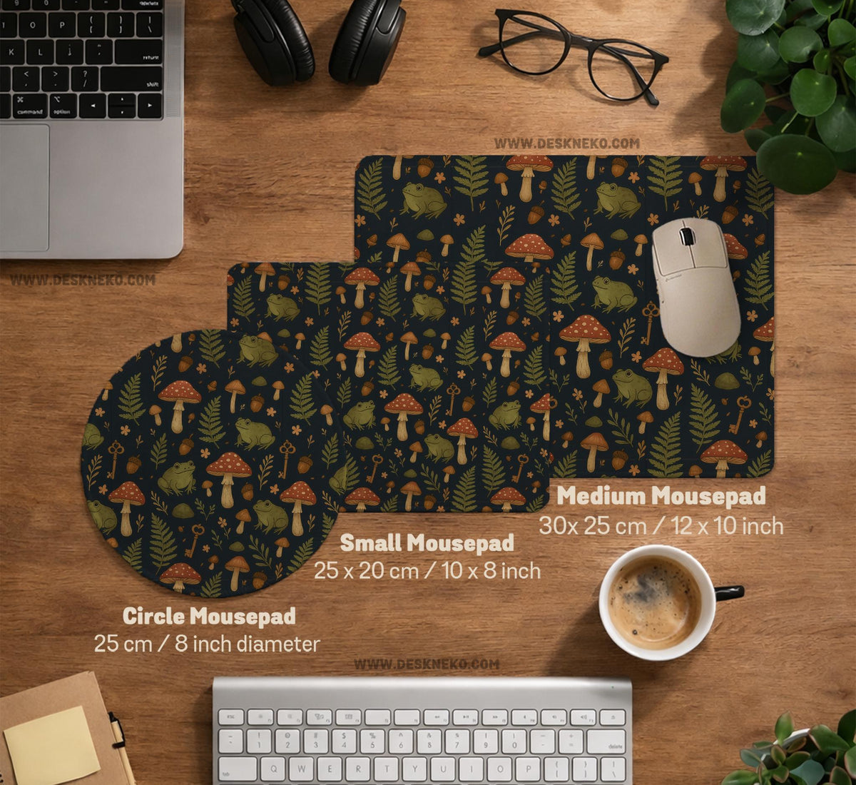 Dark forest-themed desk mat with an all-over pattern of frogs, mushrooms, fern leaves, acorns, tiny flowers, and antique keys.