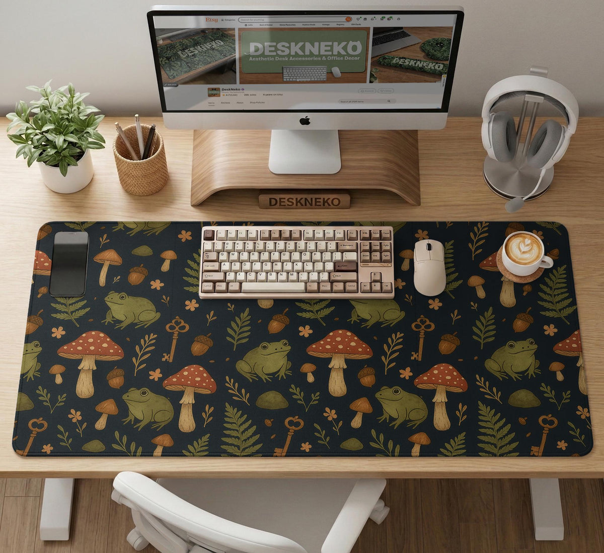 Dark forest-themed desk mat with an all-over pattern of frogs, mushrooms, fern leaves, acorns, tiny flowers, and antique keys.