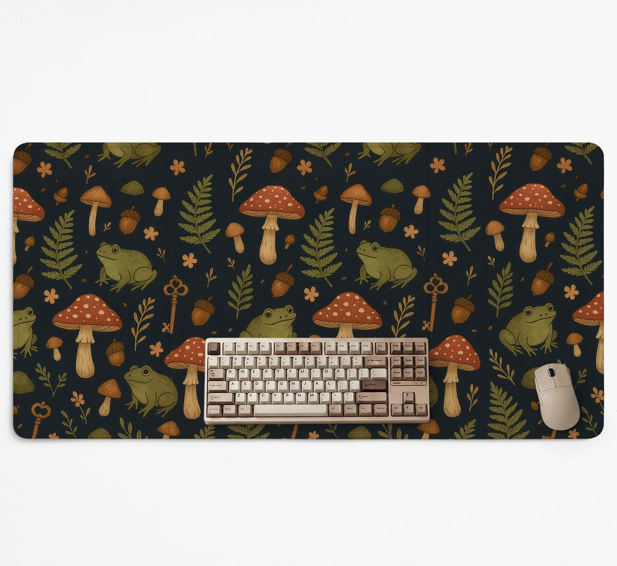 Dark forest-themed desk mat with an all-over pattern of frogs, mushrooms, fern leaves, acorns, tiny flowers, and antique keys.