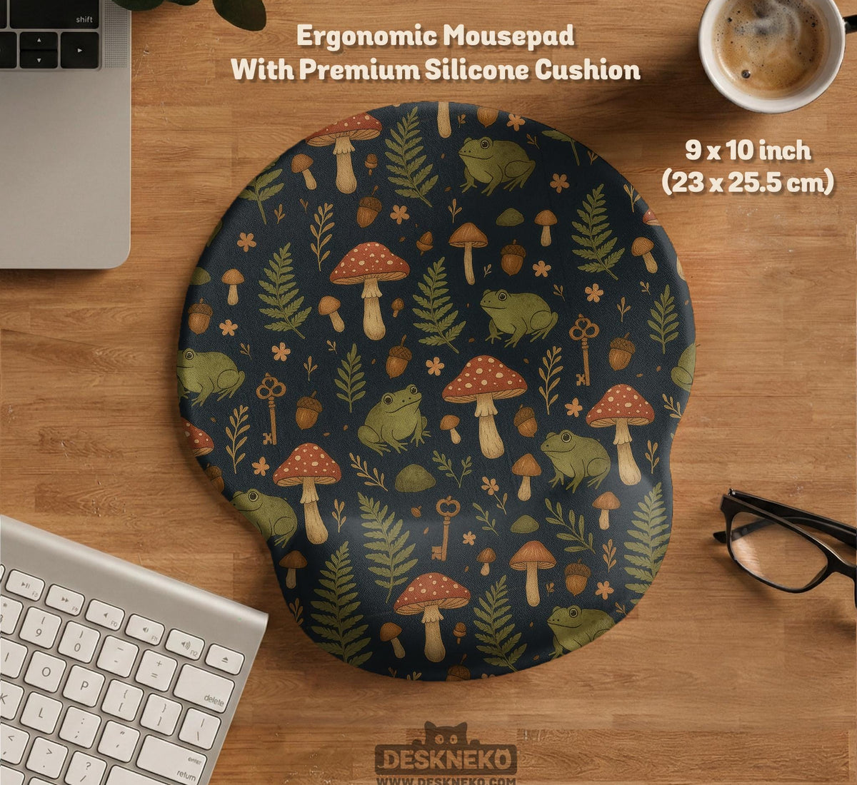 Dark forest-themed desk mat with an all-over pattern of frogs, mushrooms, fern leaves, acorns, tiny flowers, and antique keys.