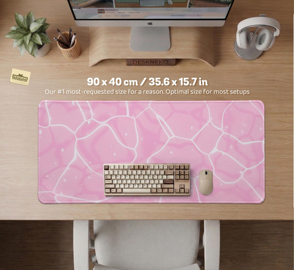 Pastel pink desk mat with a marble-style design, white flowing lines, and small sparkle accents.