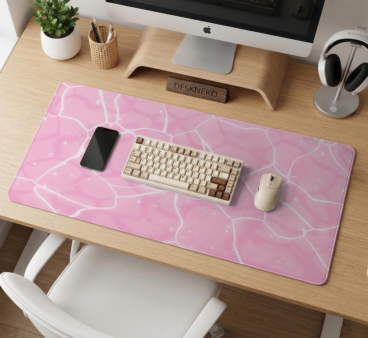 Pastel pink desk mat with a marble-style design, white flowing lines, and small sparkle accents.