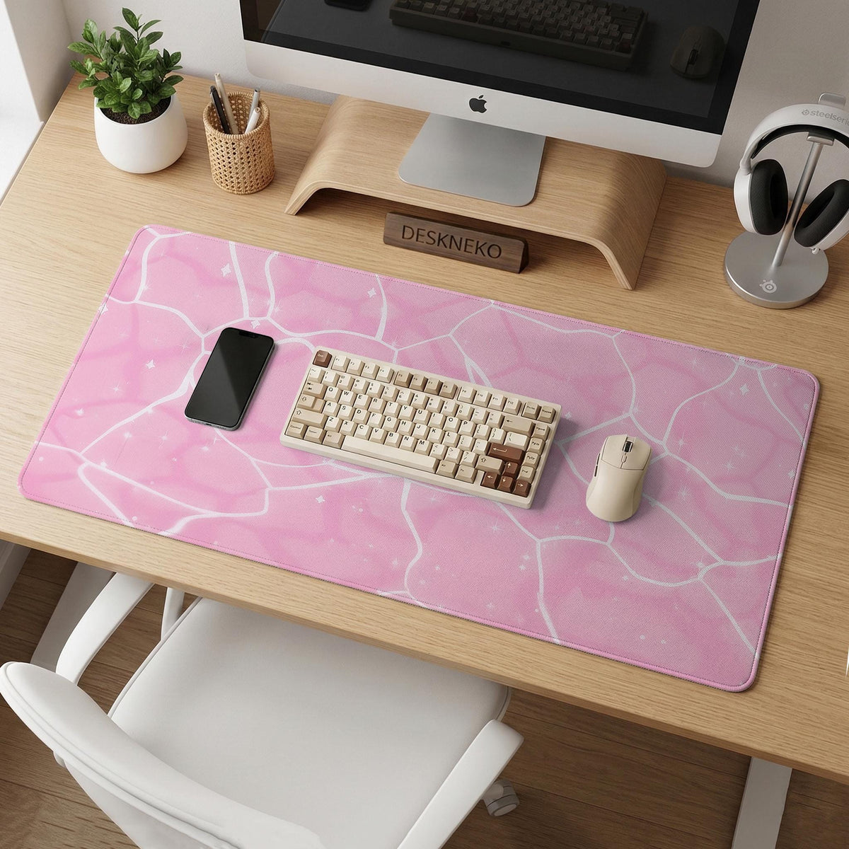 Pastel pink desk mat with a marble-style design, white flowing lines, and small sparkle accents.