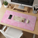 Pastel pink desk mat with a marble-style design, white flowing lines, and small sparkle accents.