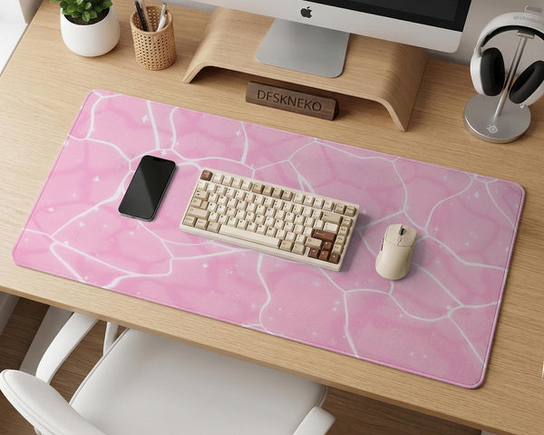 Pastel pink desk mat with a marble-style design, white flowing lines, and small sparkle accents.