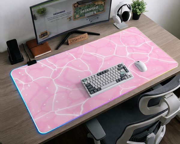 Pastel pink desk mat with a marble-style design, white flowing lines, and small sparkle accents.