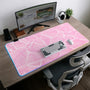 Pastel pink desk mat with a marble-style design, white flowing lines, and small sparkle accents.