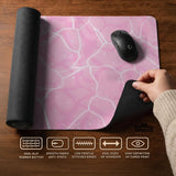 Pastel pink desk mat with a marble-style design, white flowing lines, and small sparkle accents.