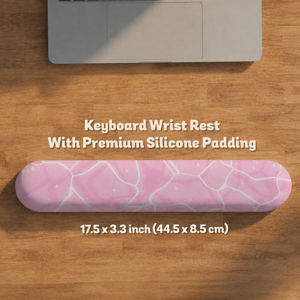 Pastel pink desk mat with a marble-style design, white flowing lines, and small sparkle accents.