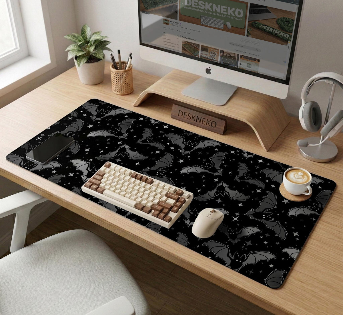 Black desk mat with a dark bat pattern and scattered stars on a charcoal background.