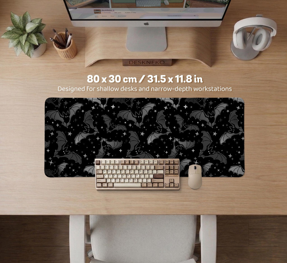Black desk mat with a dark bat pattern and scattered stars on a charcoal background.
