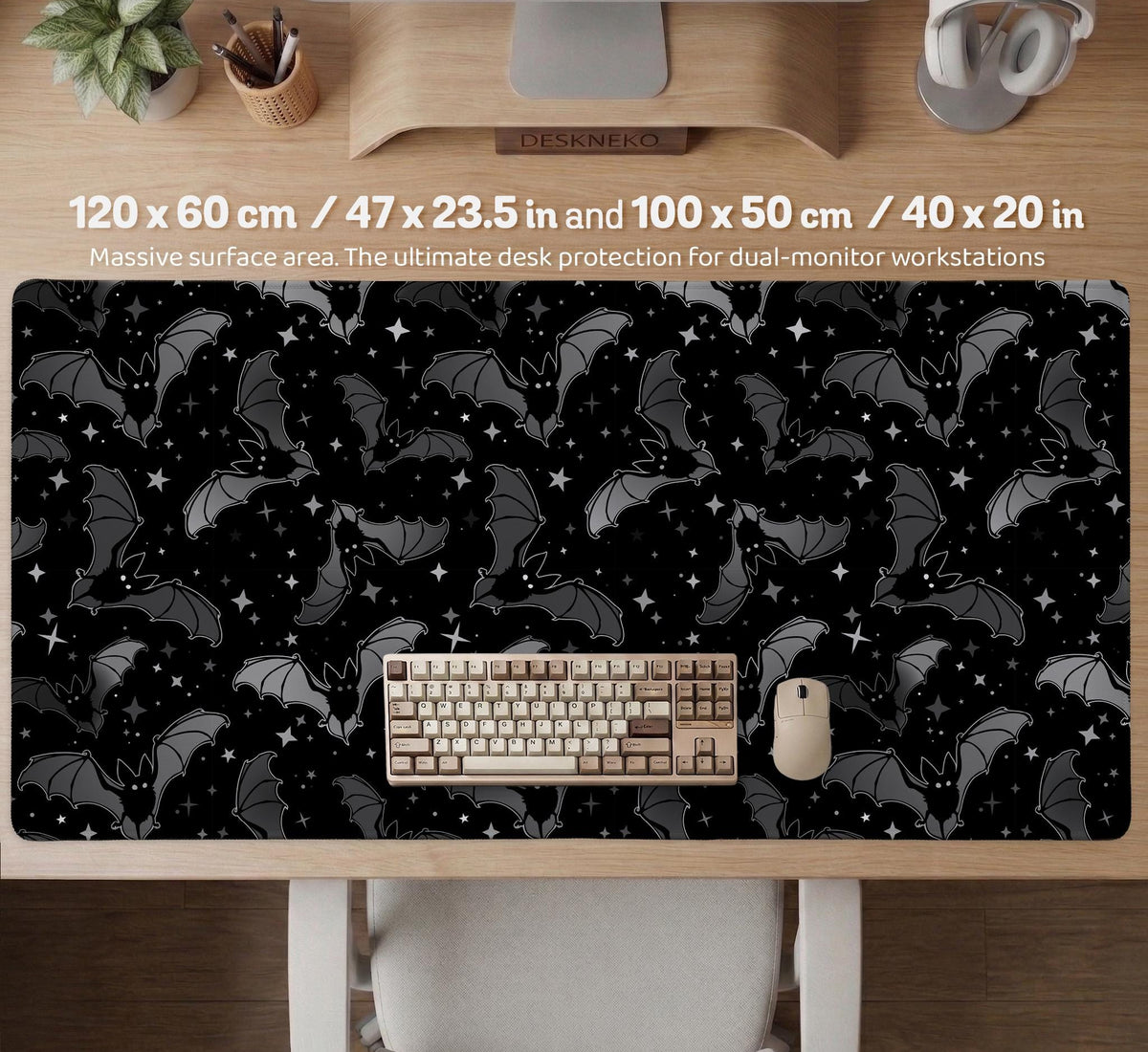 Black desk mat with a dark bat pattern and scattered stars on a charcoal background.