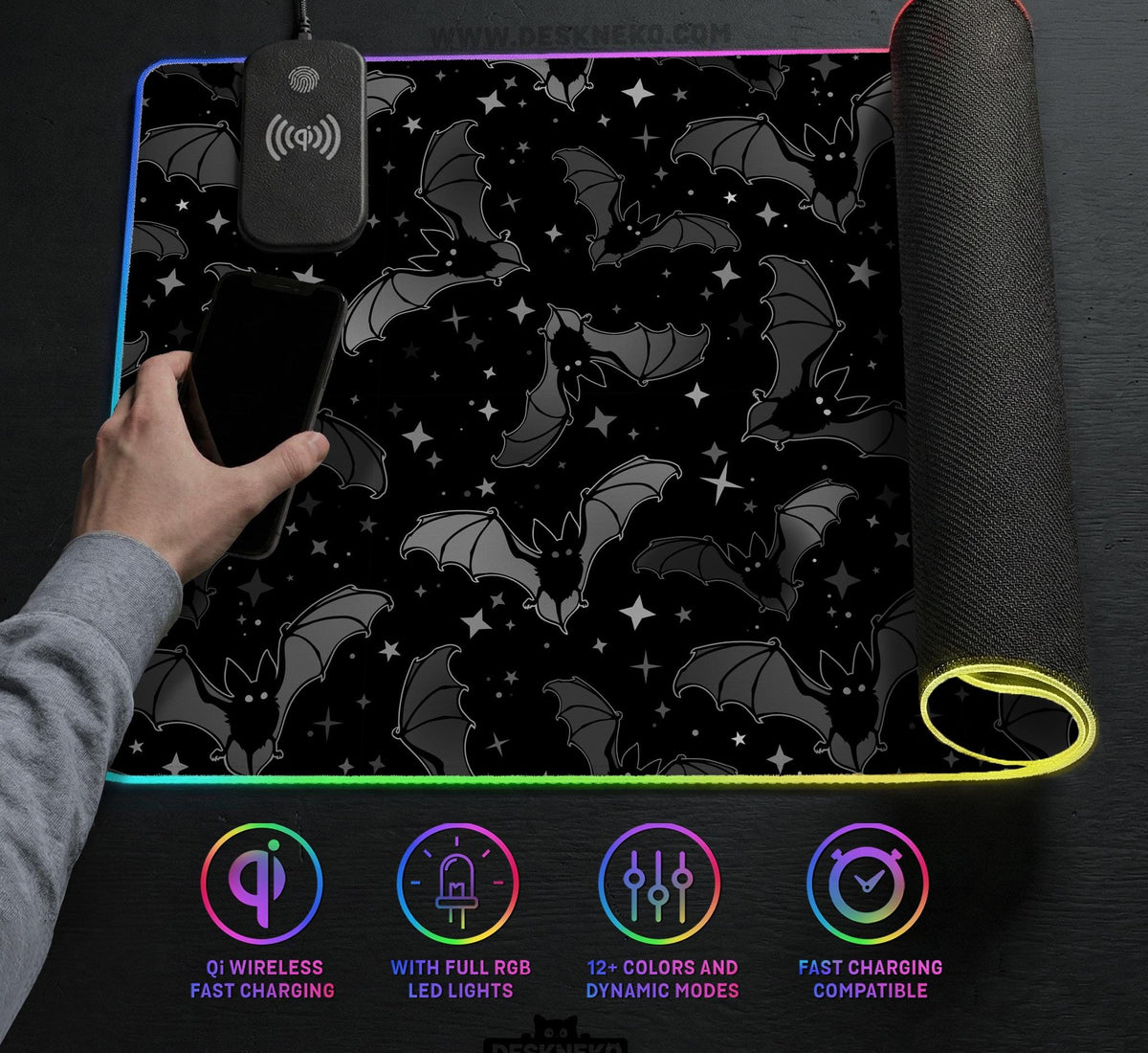 Black desk mat with a dark bat pattern and scattered stars on a charcoal background.