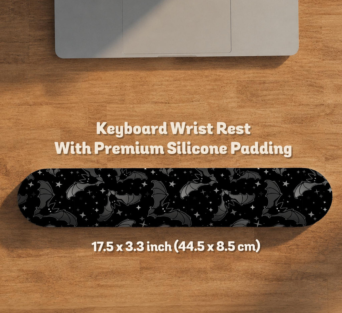 Black desk mat with a dark bat pattern and scattered stars on a charcoal background.