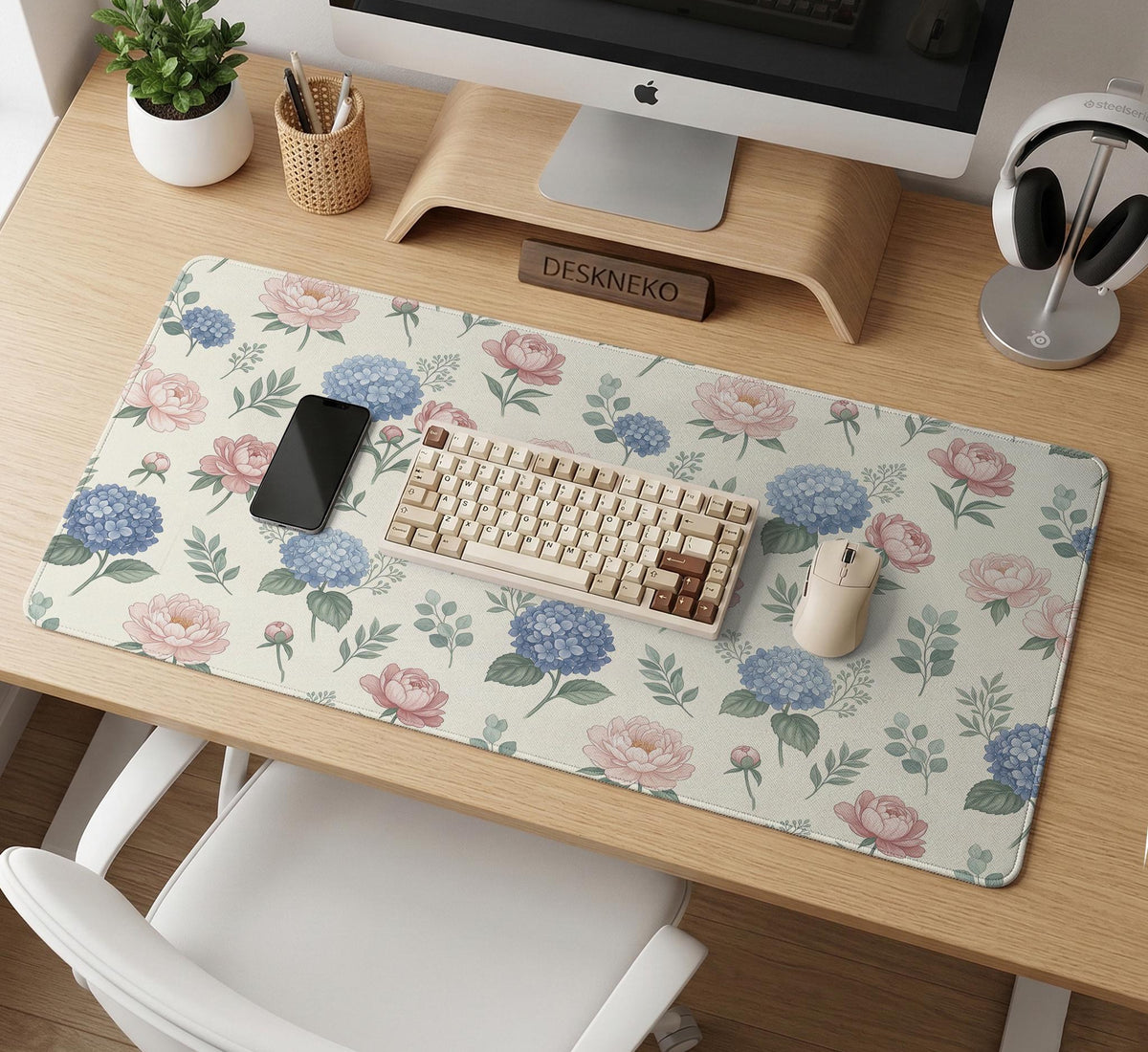 Floral desk mat with sage greenery, pink peonies, blue flowers, and a warm cream background.