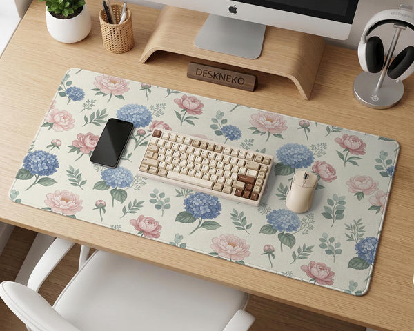 Floral desk mat with sage greenery, pink peonies, blue flowers, and a warm cream background.