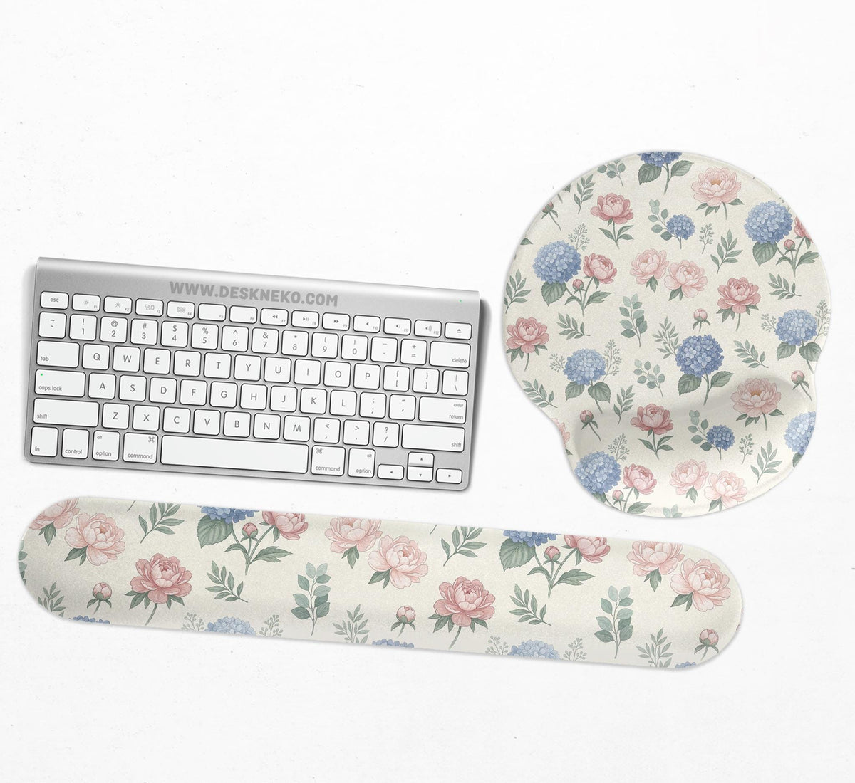 Mousepad and keyboard wrist rest with a floral print of blue hydrangeas, pink peonies, sage leaves, and a cream background.