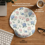 Mousepad and keyboard wrist rest with a floral print of blue hydrangeas, pink peonies, sage leaves, and a cream background.