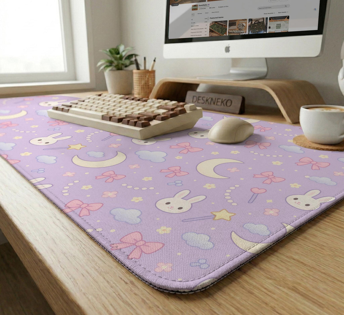 Pastel lavender desk mat with an all-over pattern of bunnies, crescent moons, clouds, bows, stars, and small flowers.