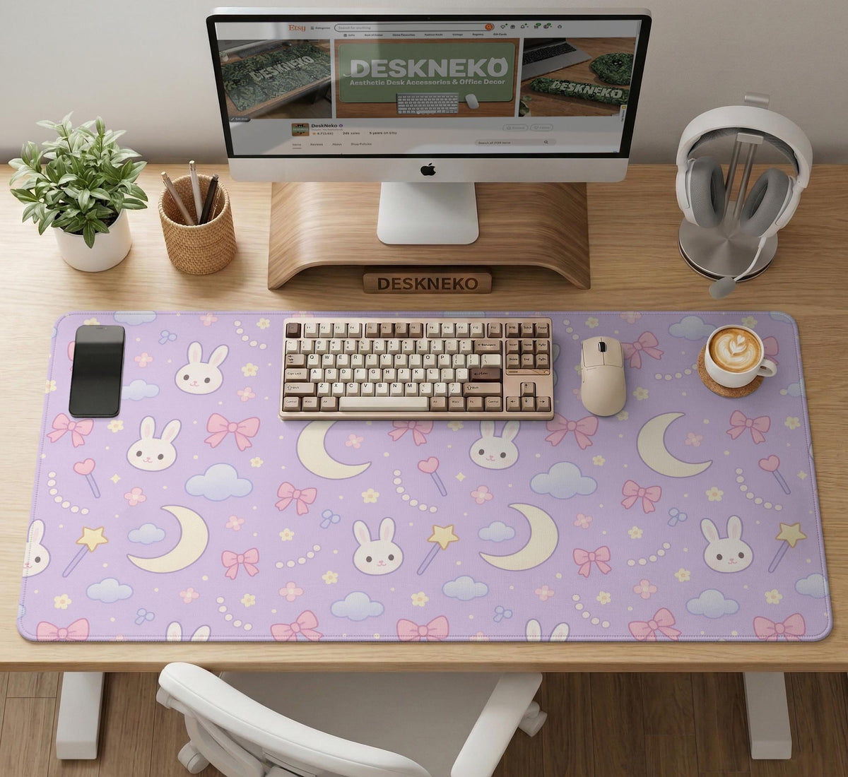 Lavender desk mat with an all-over pattern of bunny faces, clouds, moons, bows, and flowers in pastel colors.