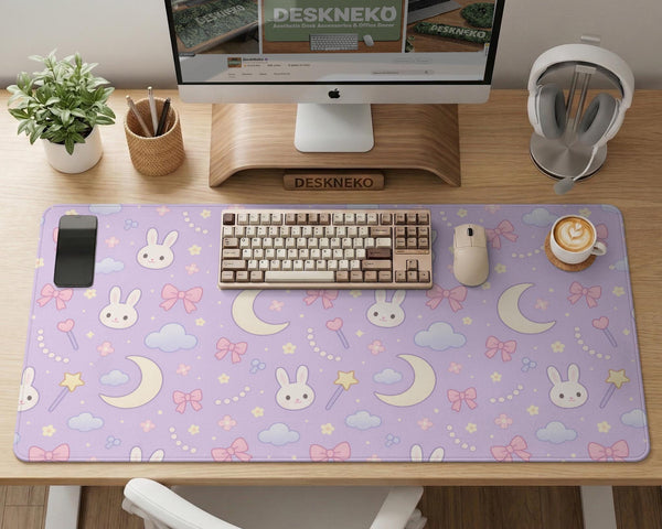 Pastel lavender desk mat with an all-over pattern of bunnies, crescent moons, clouds, bows, stars, and small flowers.