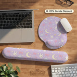 Lavender desk mat with an all-over pattern of bunny faces, clouds, moons, bows, and flowers in pastel colors.