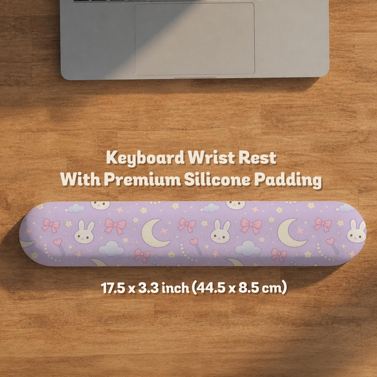 Lavender desk mat with an all-over pattern of bunny faces, clouds, moons, bows, and flowers in pastel colors.