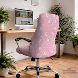 Pink chair cover with bunny faces, crescent moons, clouds, and bows on a white chair.