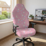 Pink chair cover with bunny faces, crescent moons, clouds, and bows on a white chair.