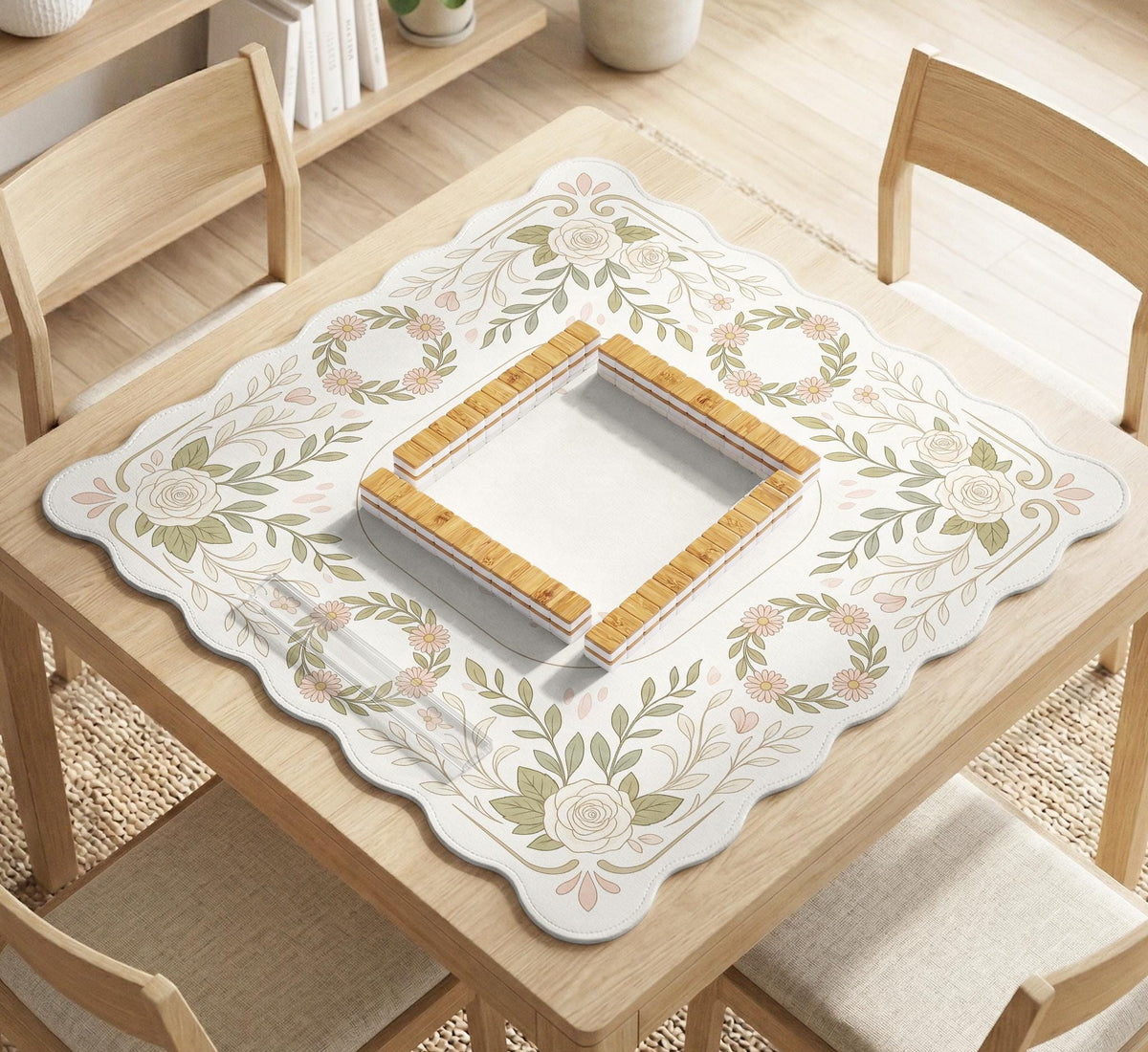 Square mahjong mat with a light floral border in sage green, cream, and blush around a plain center play area.