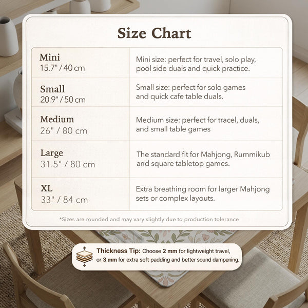 Square mahjong mat with a light floral border in sage green, cream, and blush around a plain center play area.