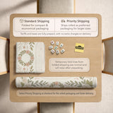 Square mahjong mat with a light floral border in sage green, cream, and blush around a plain center play area.