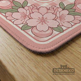 Square pink mahjong mat with a gingham border, floral corner details, and ribbon accents on a light background.