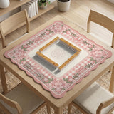 Square pink mahjong mat with a gingham border, floral corner details, and ribbon accents on a light background.