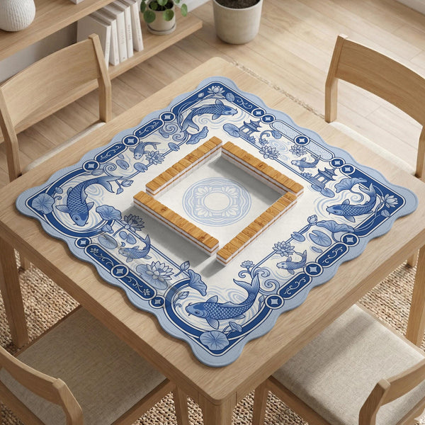 Navy blue square mahjong table mat with lotus flowers and koi fish in a porcelain-style border and a plain center.