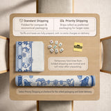 Navy blue square mahjong table mat with lotus flowers and koi fish in a porcelain-style border and a plain center.